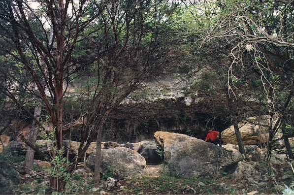 Author at ruined rockshelter below leveled field,
